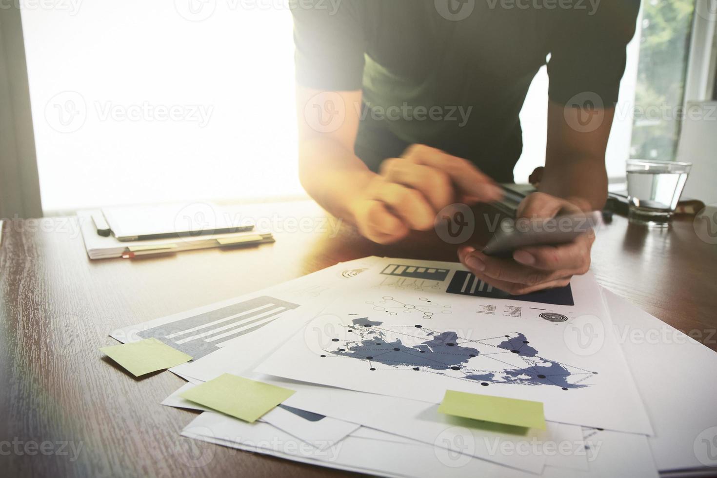 Young creative designer man working at office and smartphone as concept photo