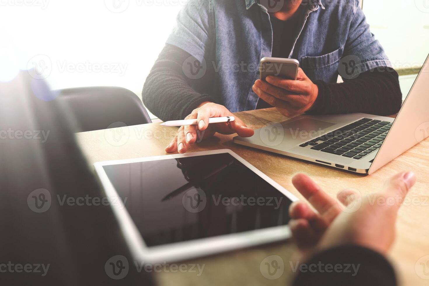 two colleague web designer discussing data and digital tablet and computer laptop with smart phone and design diagram on marble desk as concept photo