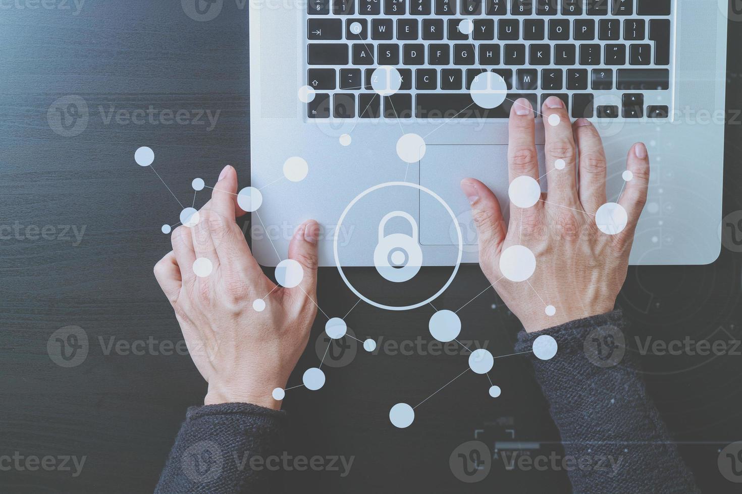 cyber security internet and networking concept.Businessman hand working with VR screen padlock icon on laptop computer photo