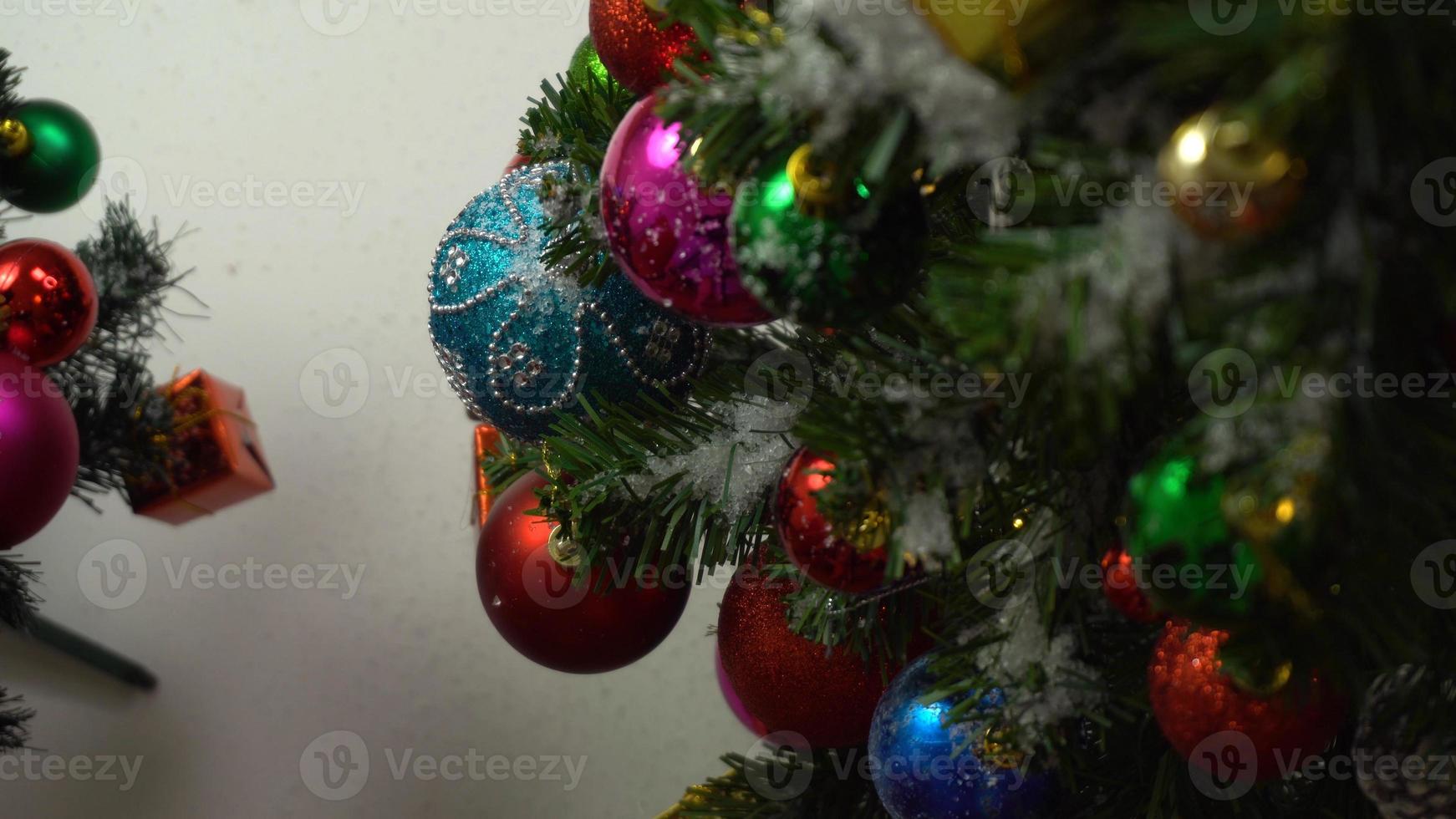 Greeting Season concept.hand setting of ornaments on a Christmas tree with decorative light photo