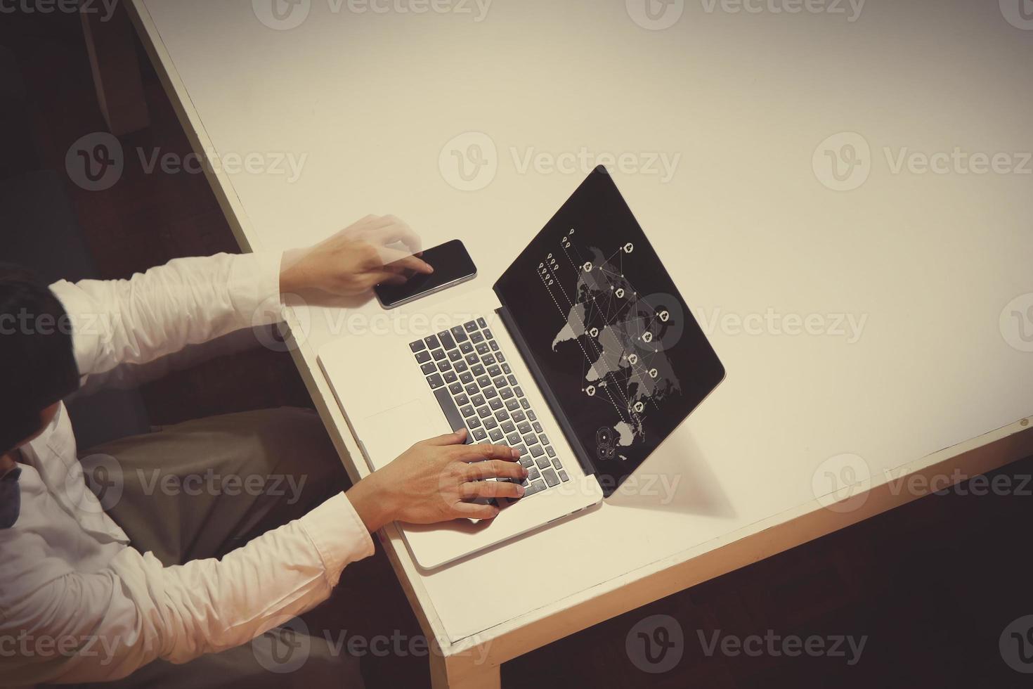 business documents on office table with digital tablet and man working with smart laptop computer background with overcast exposure effect with social media diagram photo
