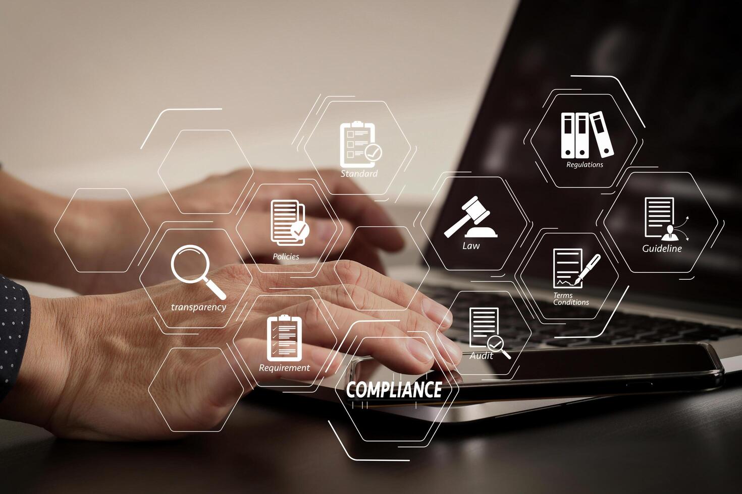 close up of businessman hand working with smart phone and laptop and digital tablet computer in modern office photo