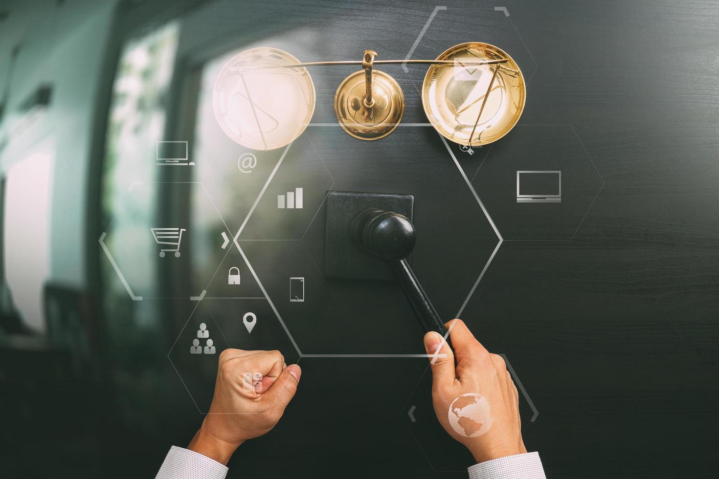 justice and law concept.Top view of Male judge hand in a courtroom with the gavel and brass scale on dark wood table with Vr diagram photo