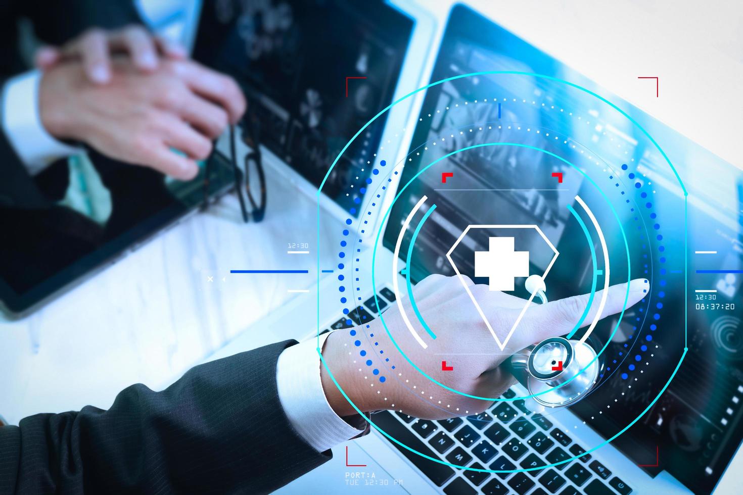 Medical technology network team meeting concept. Doctor hand working smart phone modern digital tablet laptop computer graphics chart interface, sun flare effect photo