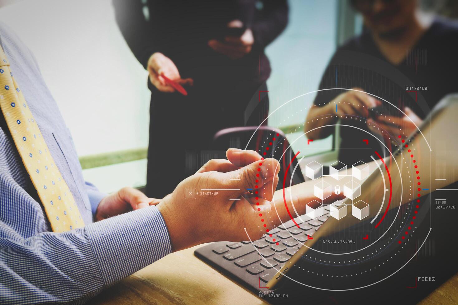 business documents on office table with smart phone and laptop computer and graph financial with social network diagram and three colleagues discussing data in the background photo