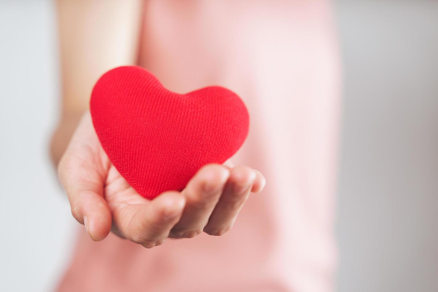 Woman holding red heart, love, health insurance, donation, happy charity volunteer, world mental health day, world heart day, valentine's day photo