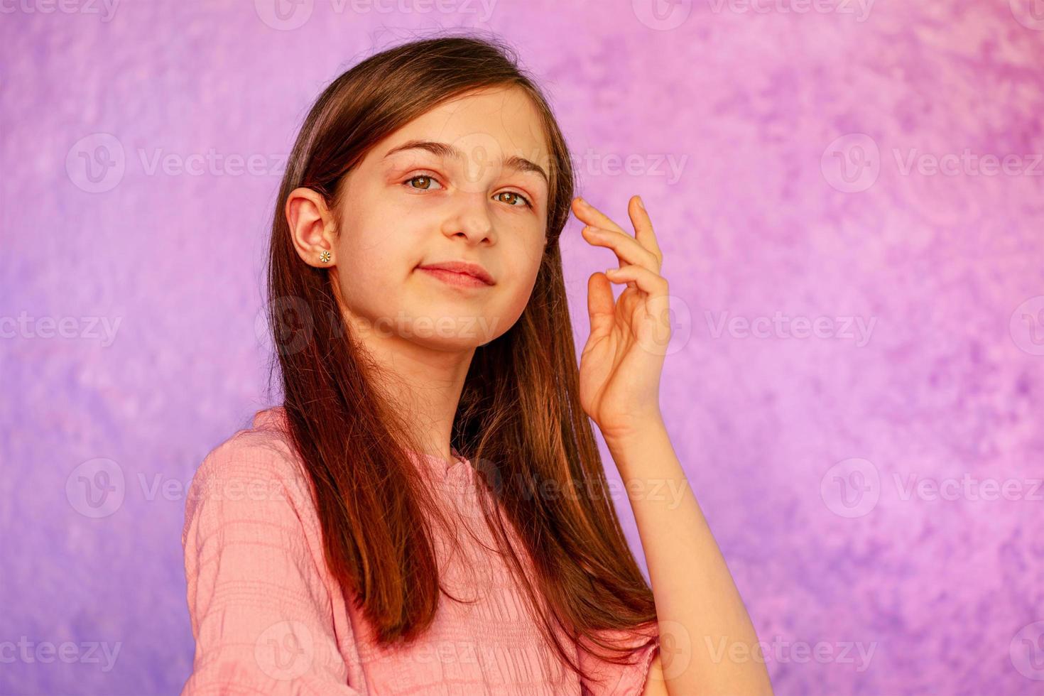 Teenage girl on a purple background. Girl portrait. photo