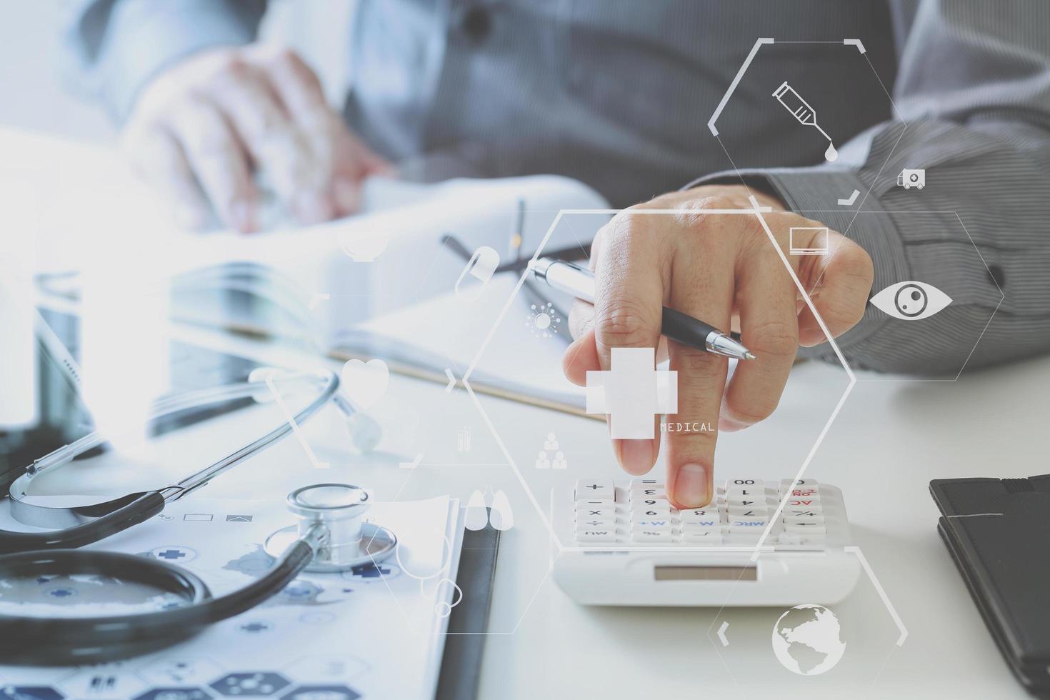 Healthcare costs and fees concept.Hand of smart doctor used a calculator for medical costs in modern hospital photo