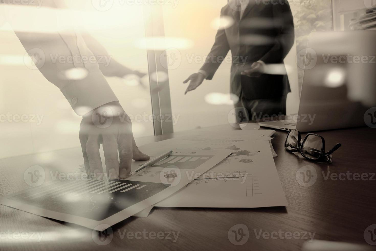 business documents on office table with smart phone and digital tablet and graph business diagram and man working in the background photo