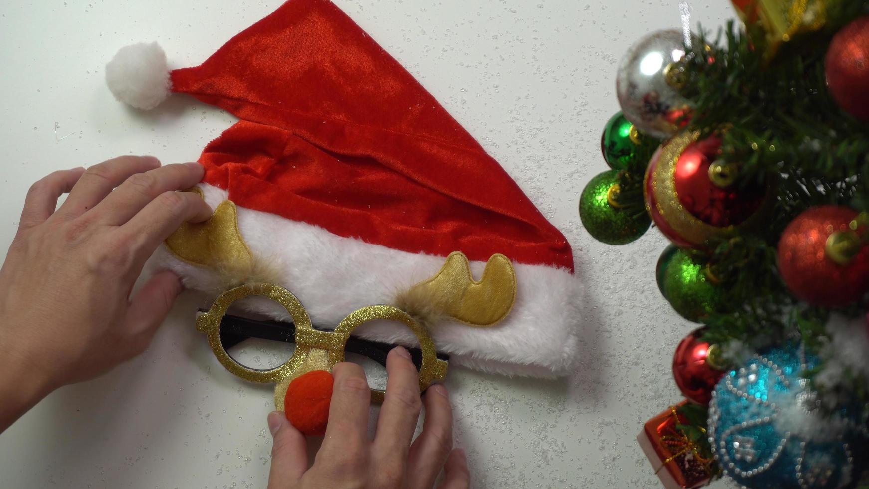 Greeting Season concept.hand setting of ornaments on a Christmas tree with decorative light photo