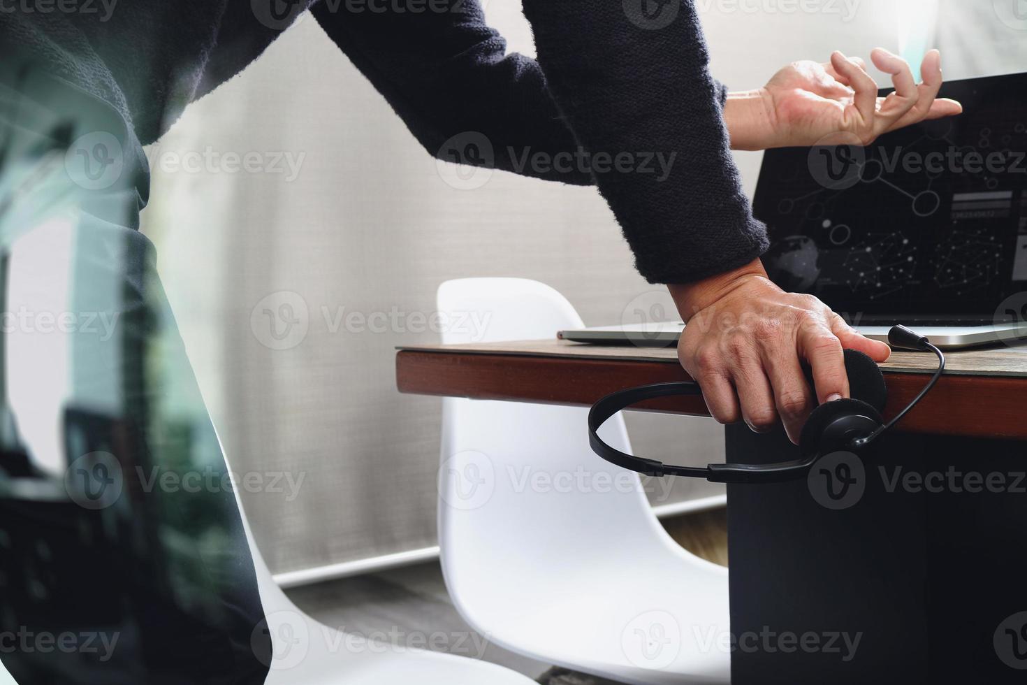 Man using VOIP headset with digital tablet computer docking smart keyboard, concept communication, it support, call center and customer service help desk photo