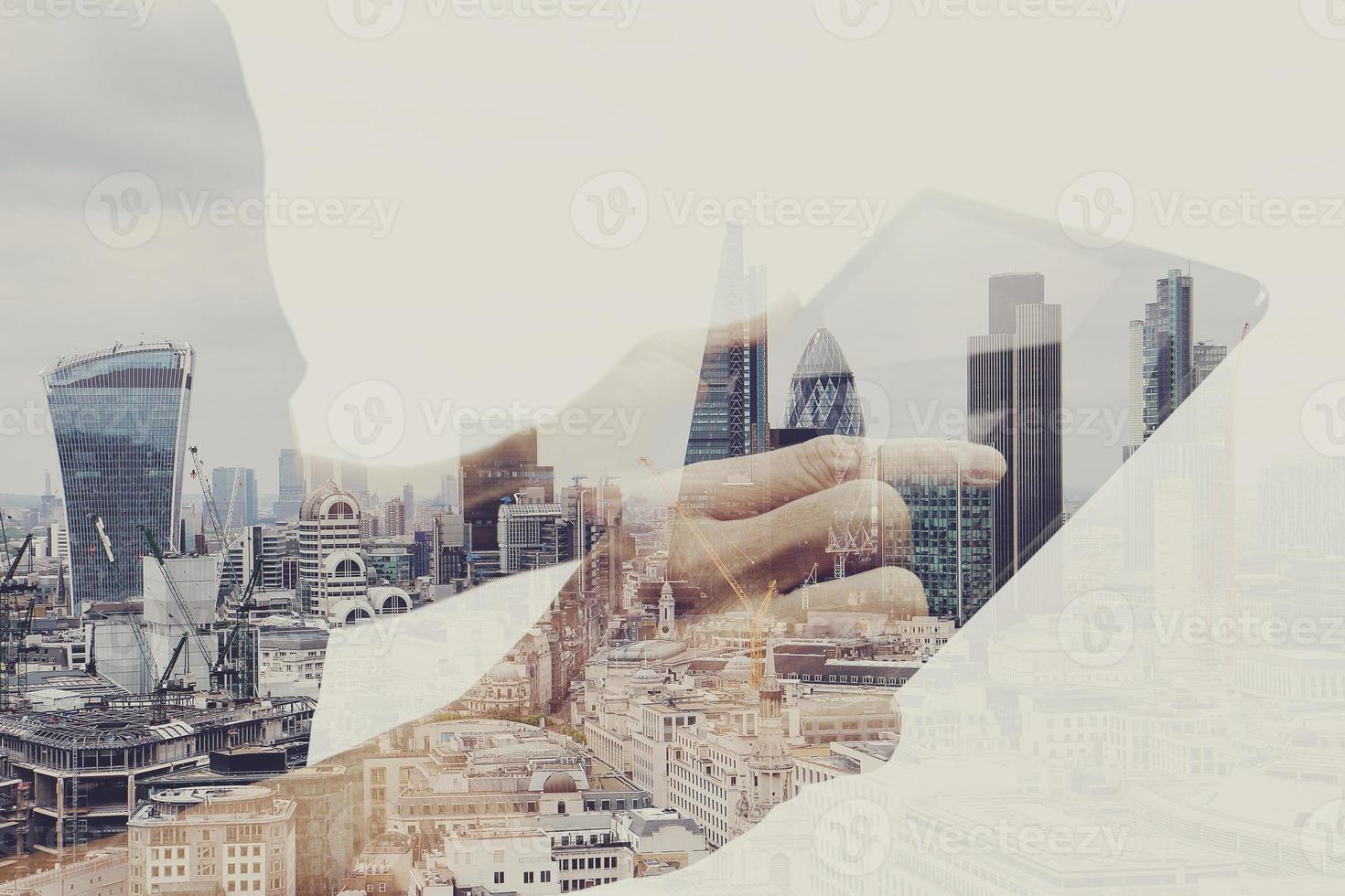 Double exposure of success businessman using digital tablet with london building and social media diagram photo