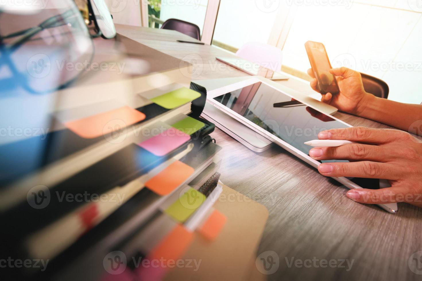 Website designer working digital tablet and computer laptop with smart phone and digital design diagram and stack of books on wooden desk as concep photo