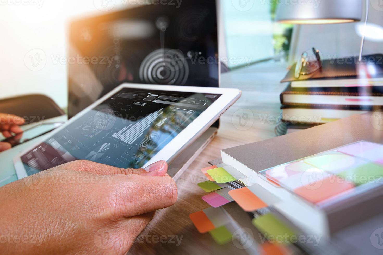 businessman working with digital tablet computer and smart phone and laptop computer with digital business strategy layer effect on wooden desk as concept photo