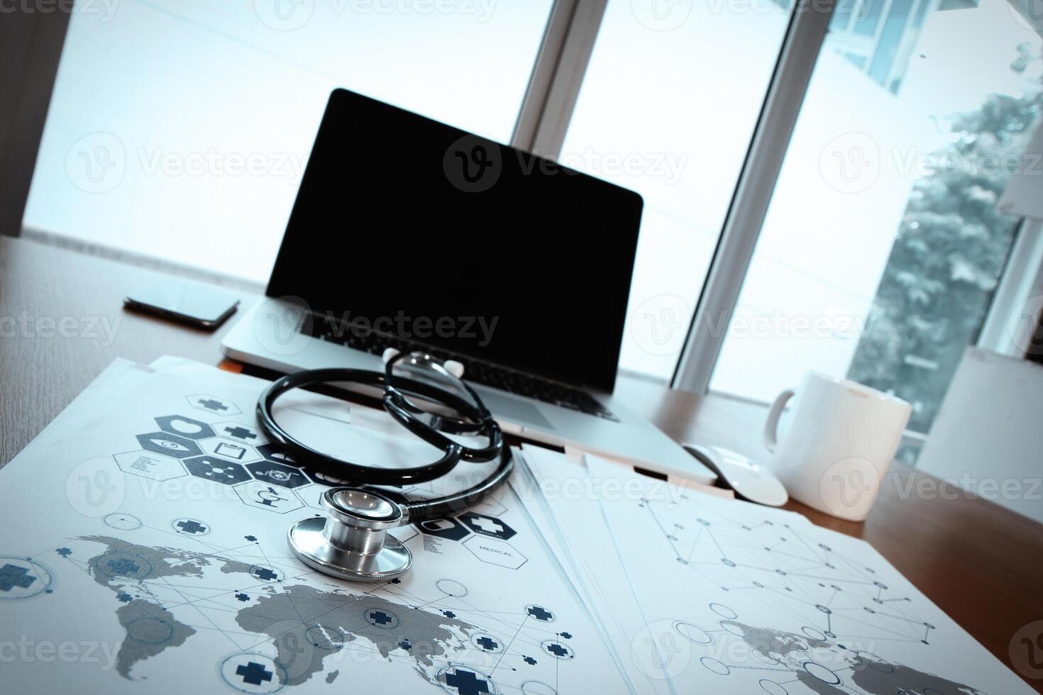 Doctor workspace with laptop computer in medical workspace office and medical network media diagram as concept photo