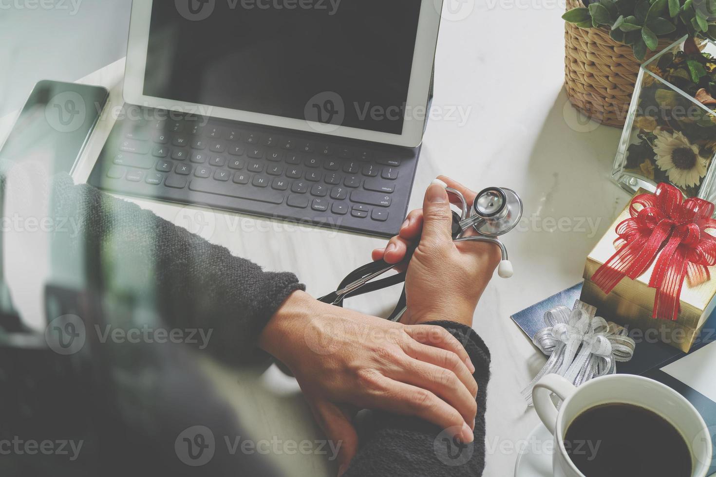 Gift giving,medical doctor Hand with credit card and hand with gift. Gift delivery, surprise,laptop computer and smart phone on mable desk,filter film effect photo