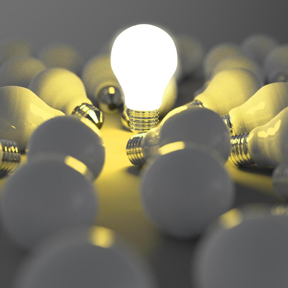 growing light bulb standing out from the unlit incandescent bulbs as leadership concept photo