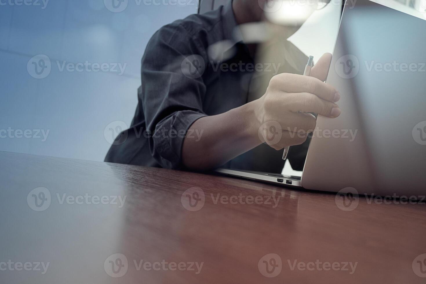 businessman hand working with new modern computer and smart phone and business strategy on wooden desk as concept photo