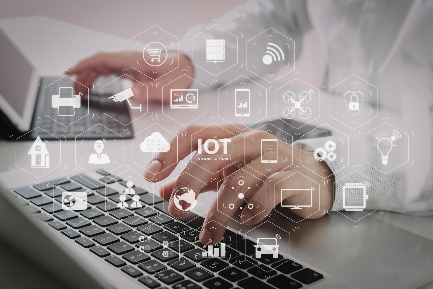 close up of businessman typing digital tablet with keyboard and laptop computer on white desk in modern office photo