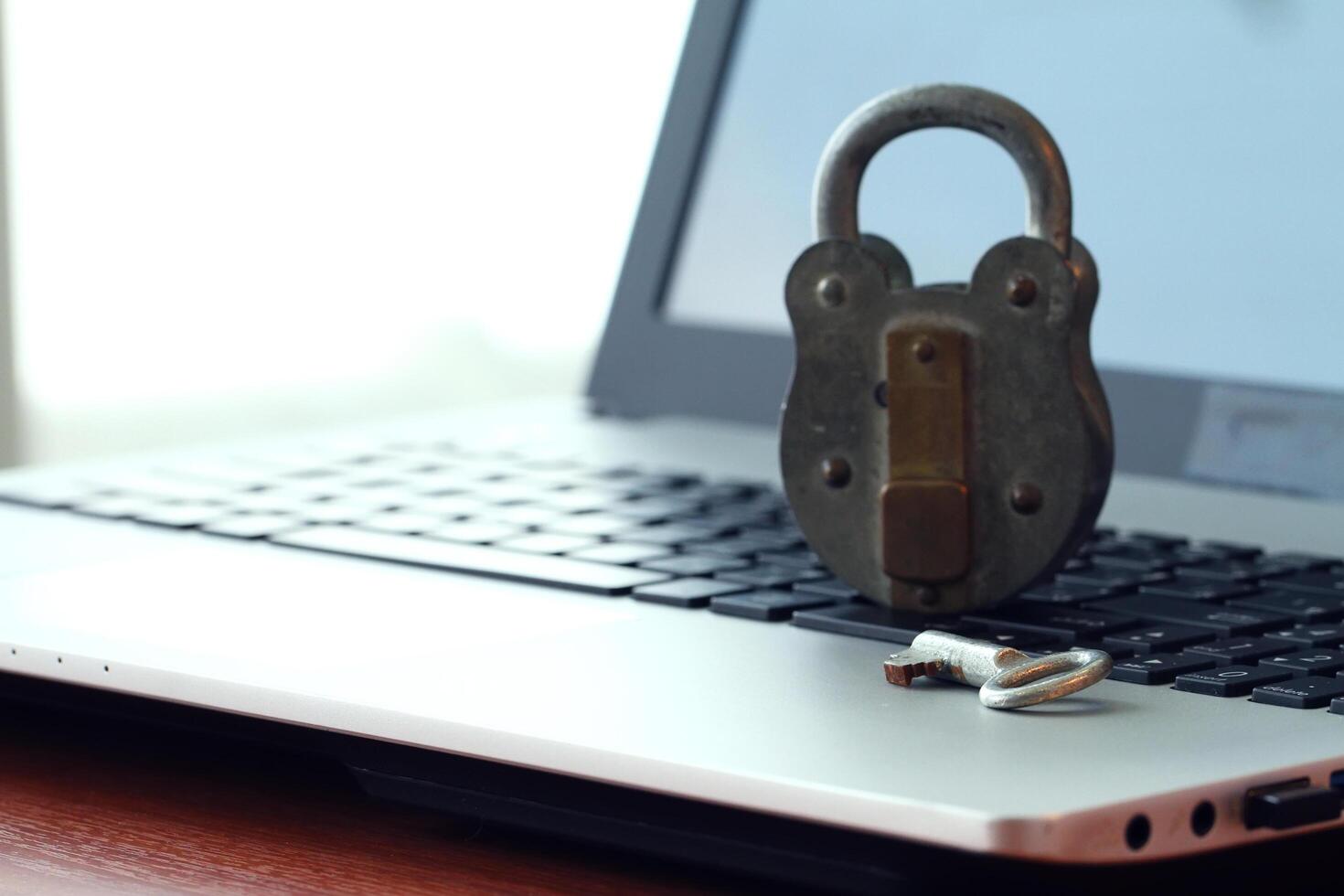 Internet security concept-old padlock and key on laptop computer keyboard photo