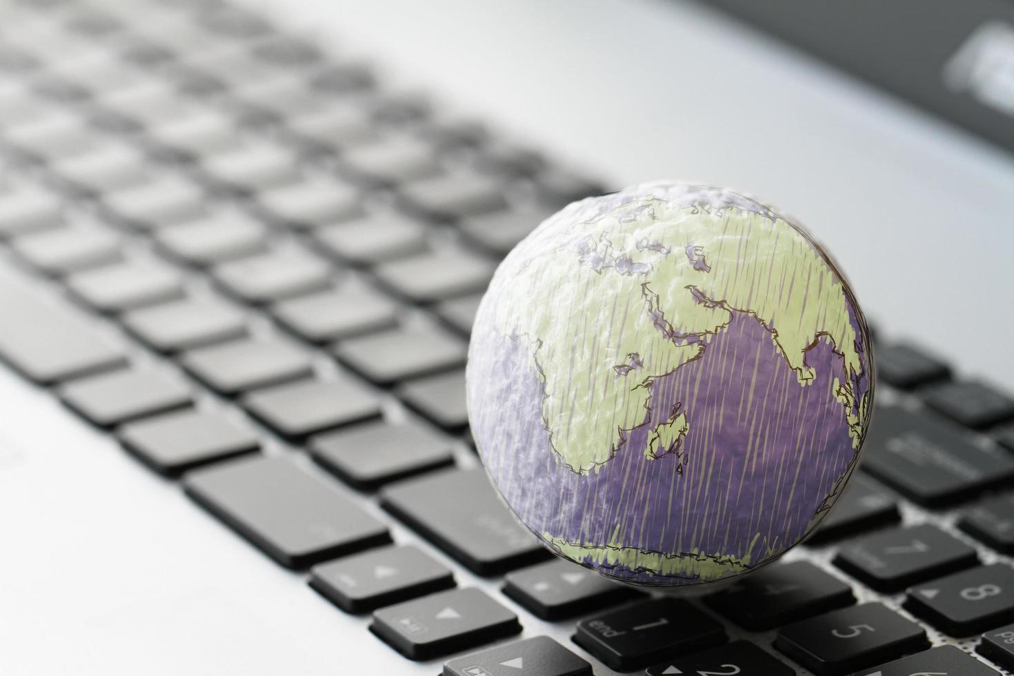 hand drawn texture globe on laptop computer as internet concept photo