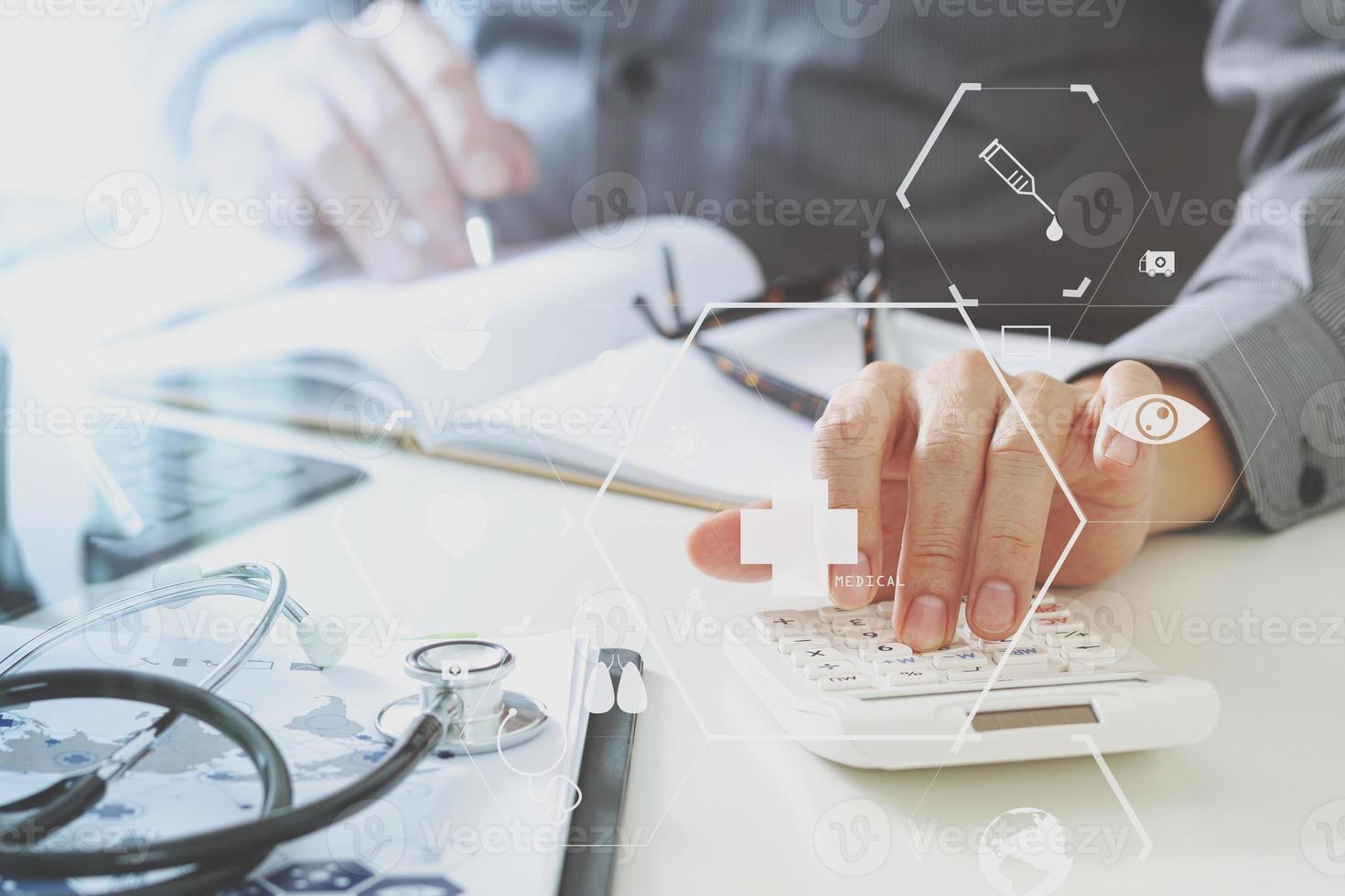 Healthcare costs and fees concept.Hand of smart doctor used a calculator for medical costs in modern hospital photo