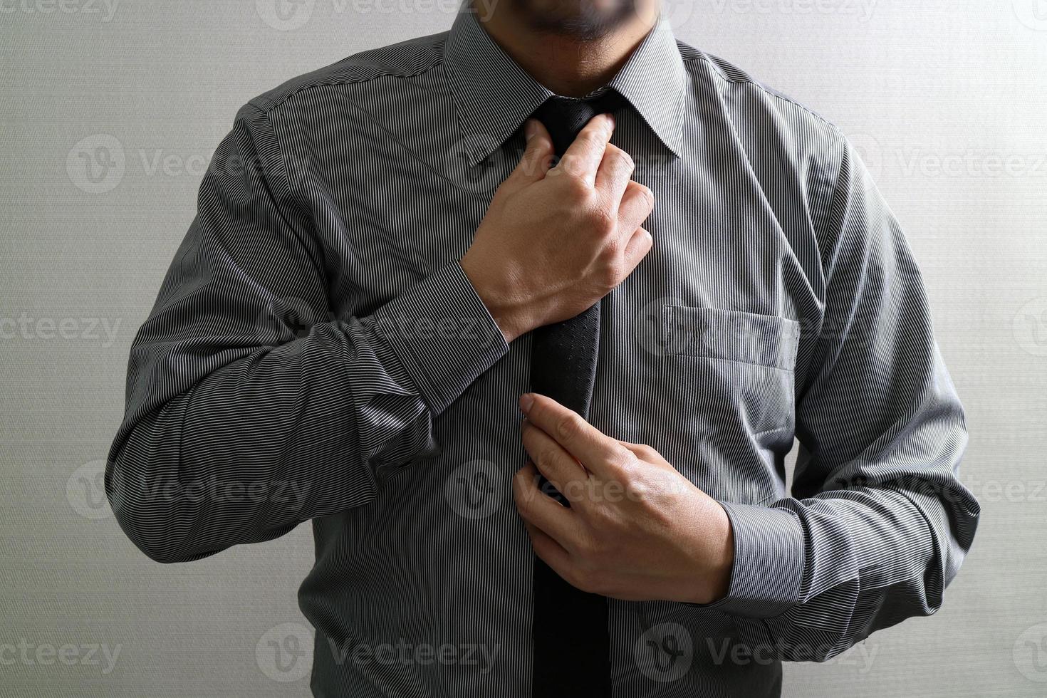 Businessman adjusting tie,Front view, no head. Concept of working in an office. photo