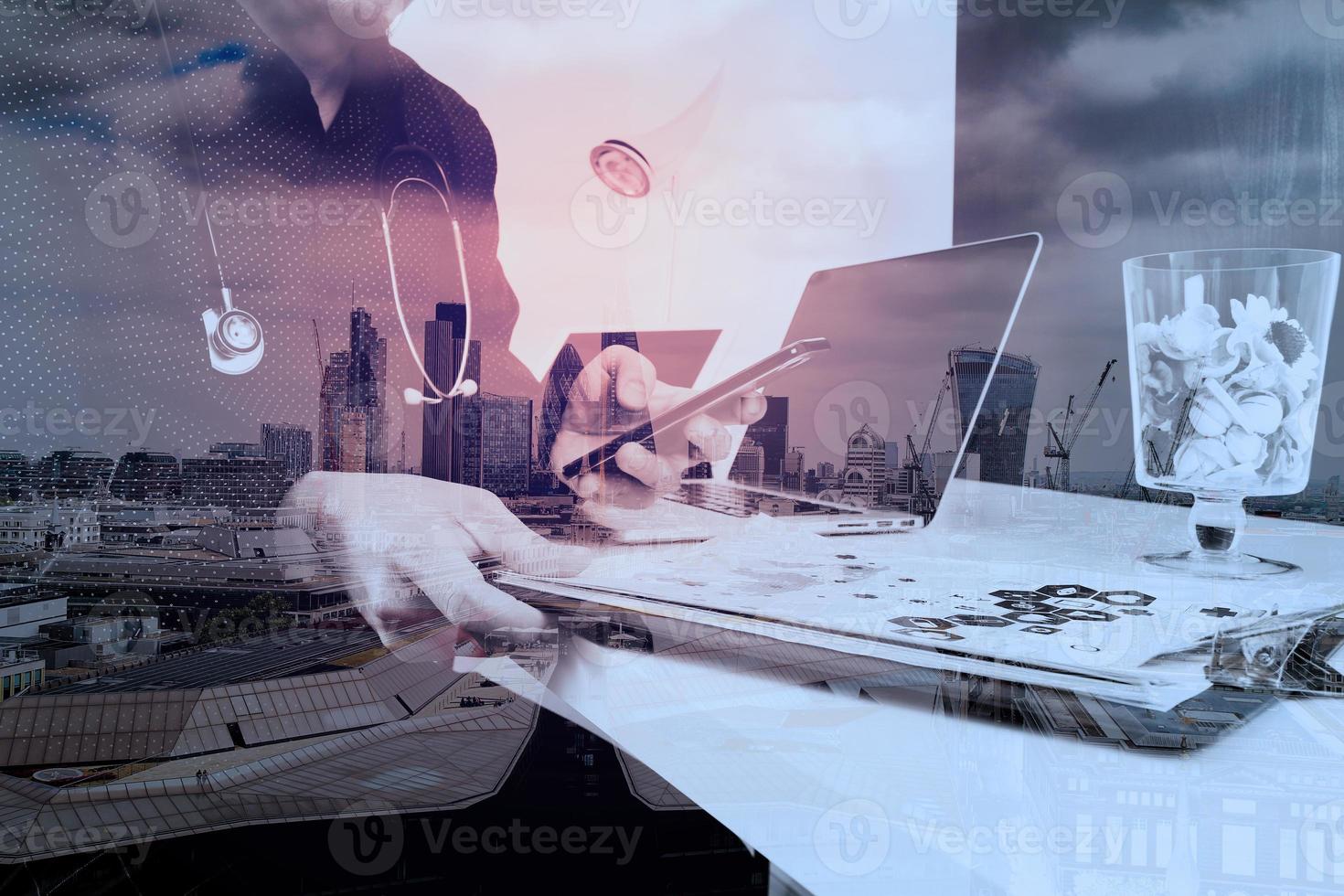 smart medical doctor working with smart phone and digital tablet and laptop computer and stethoscope on wood desk in modern office with London city exposure photo