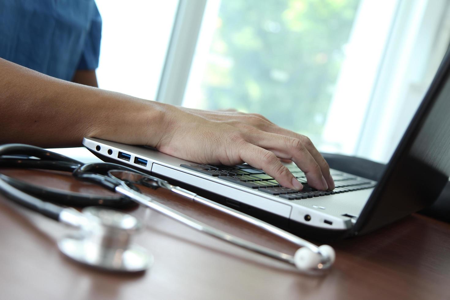 Doctor working with laptop computer in medical workspace office as concept photo