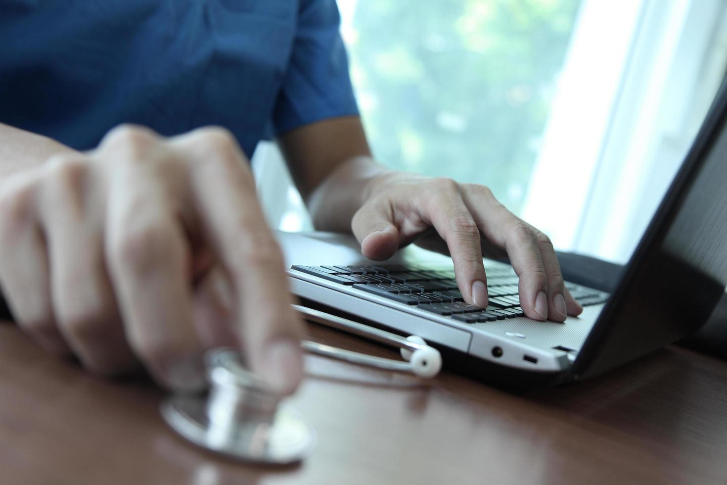 Doctor working with laptop computer in medical workspace office as concept photo