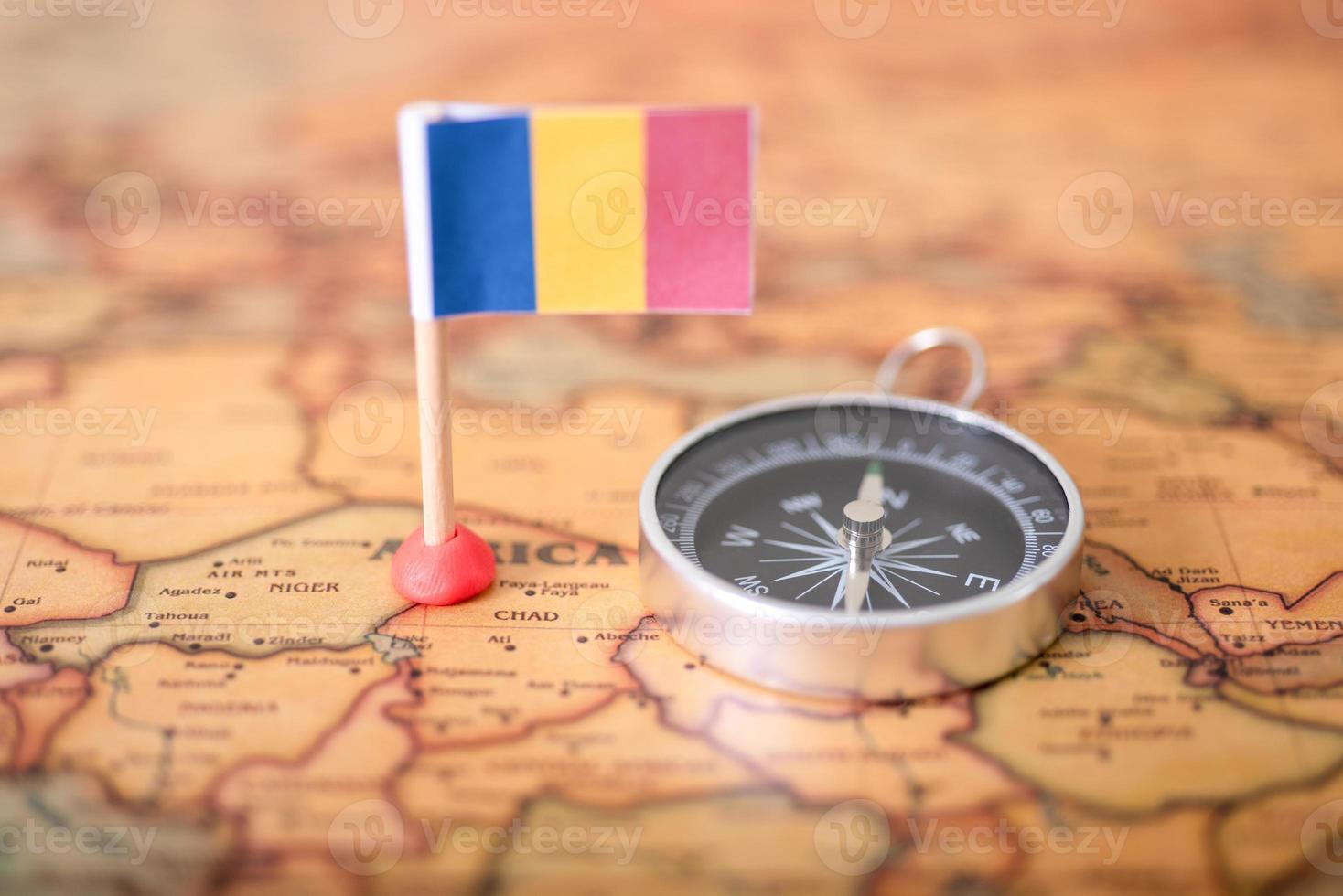 Flag of Romania and compass on the world map. photo