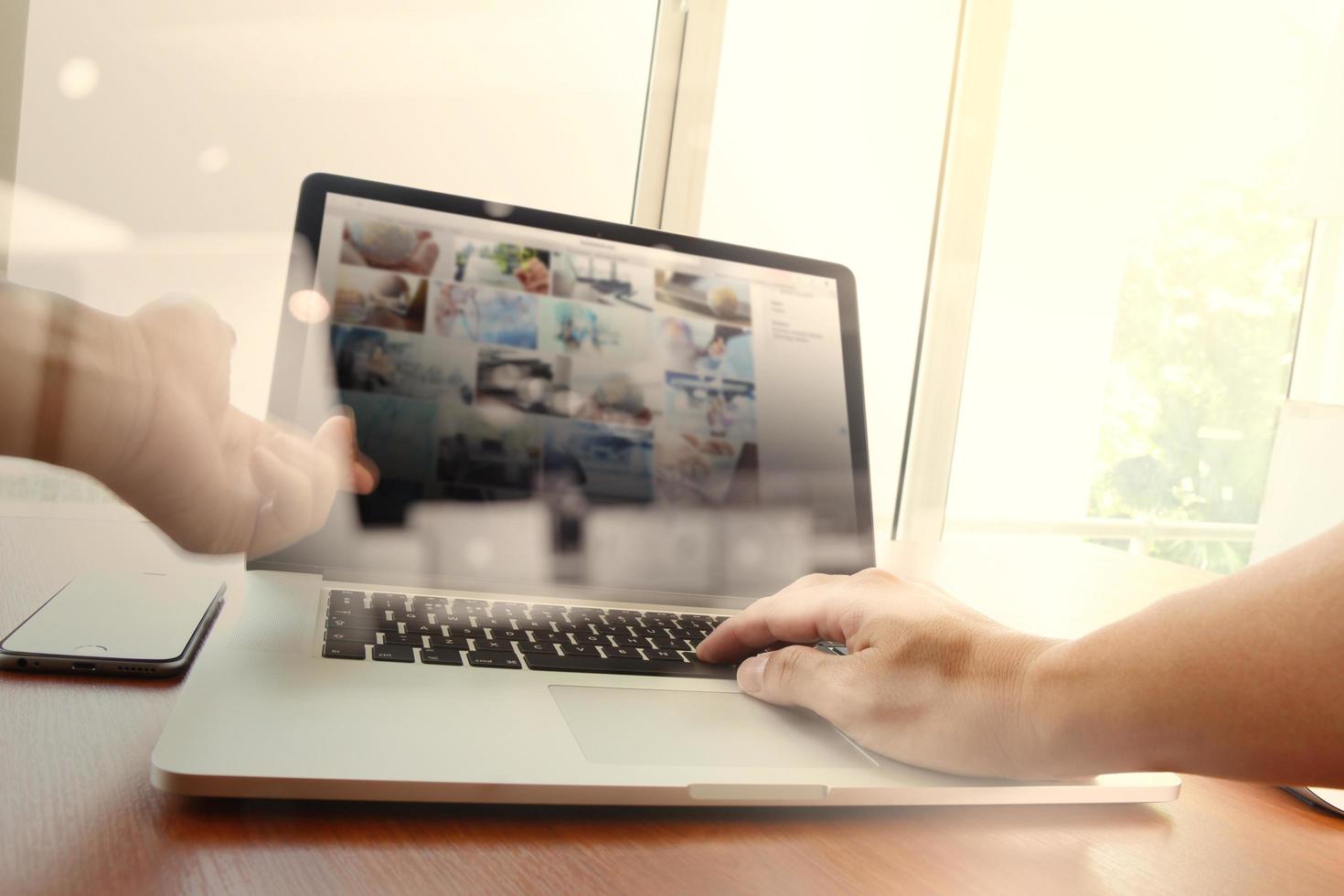 double exposure of new modern laptop computer with businessman hand working and business strategy as concept photo