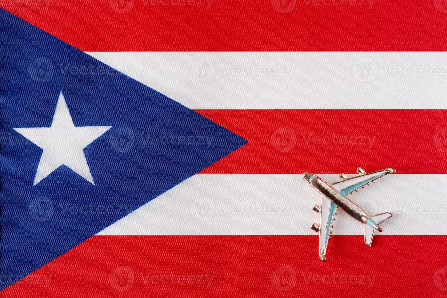 Airplane over the flag of Puerto Rico travel concept. photo