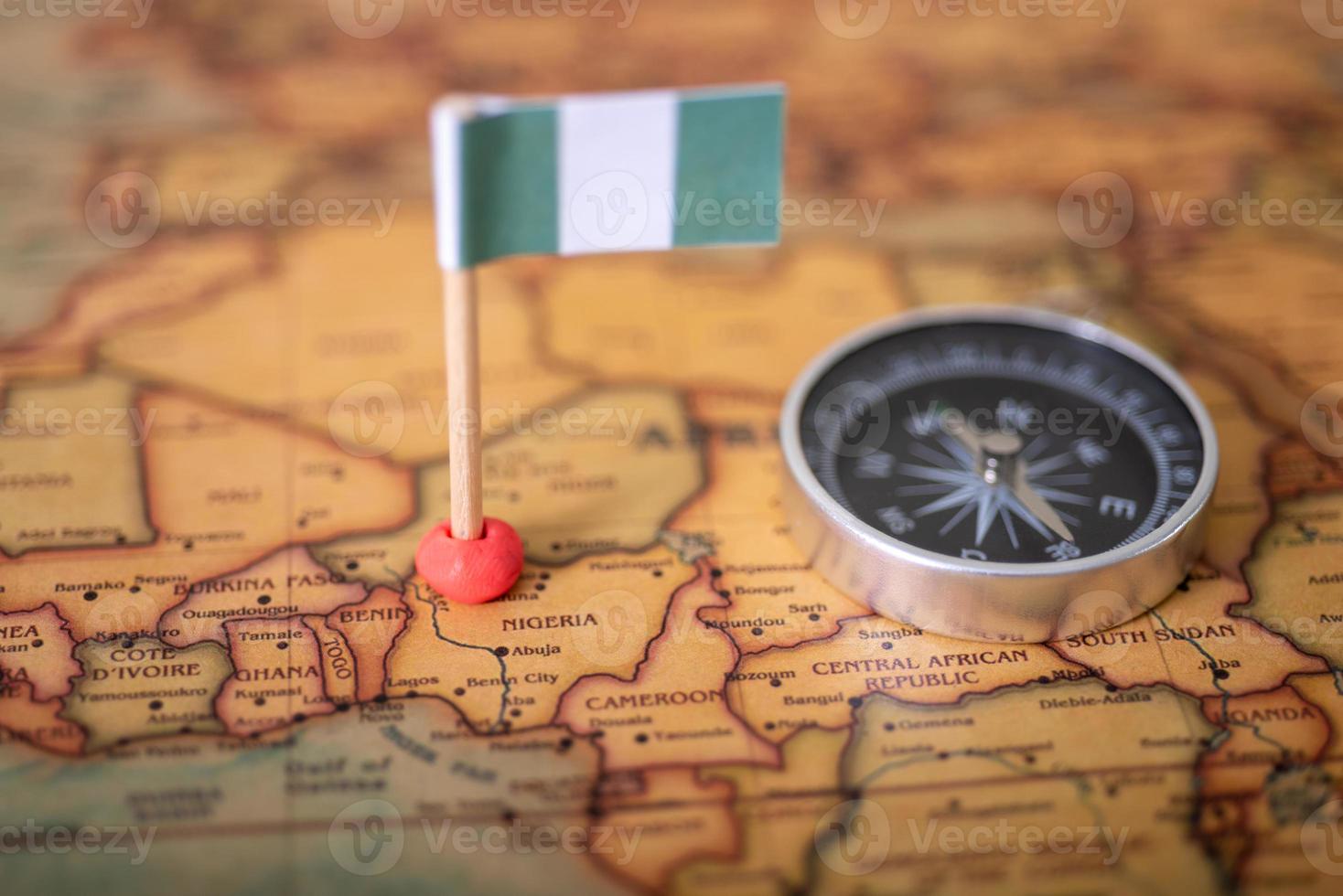 Flag of Nigeria and compass on the world map. photo