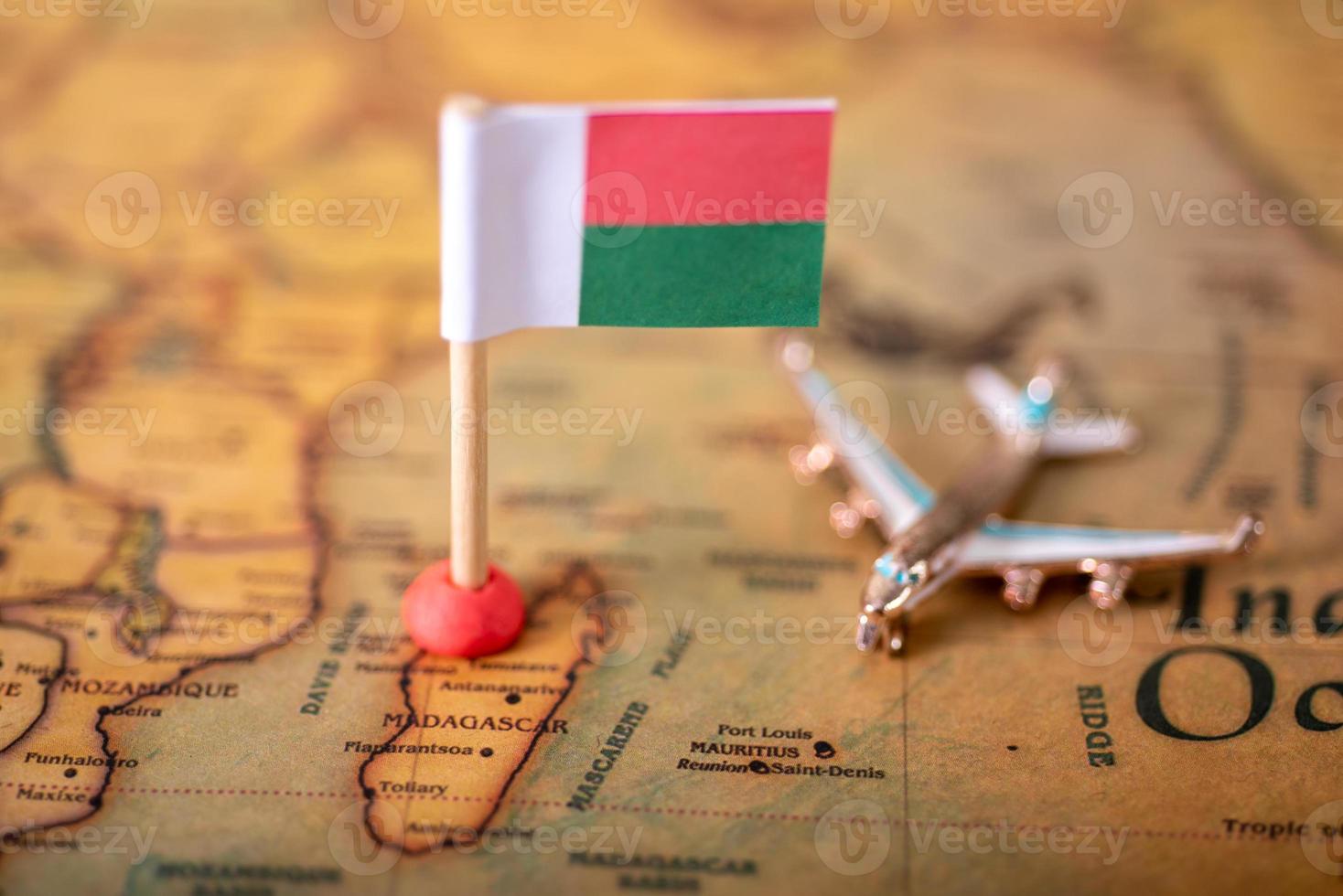 The flag of Madagascar and the plane on the world map. photo
