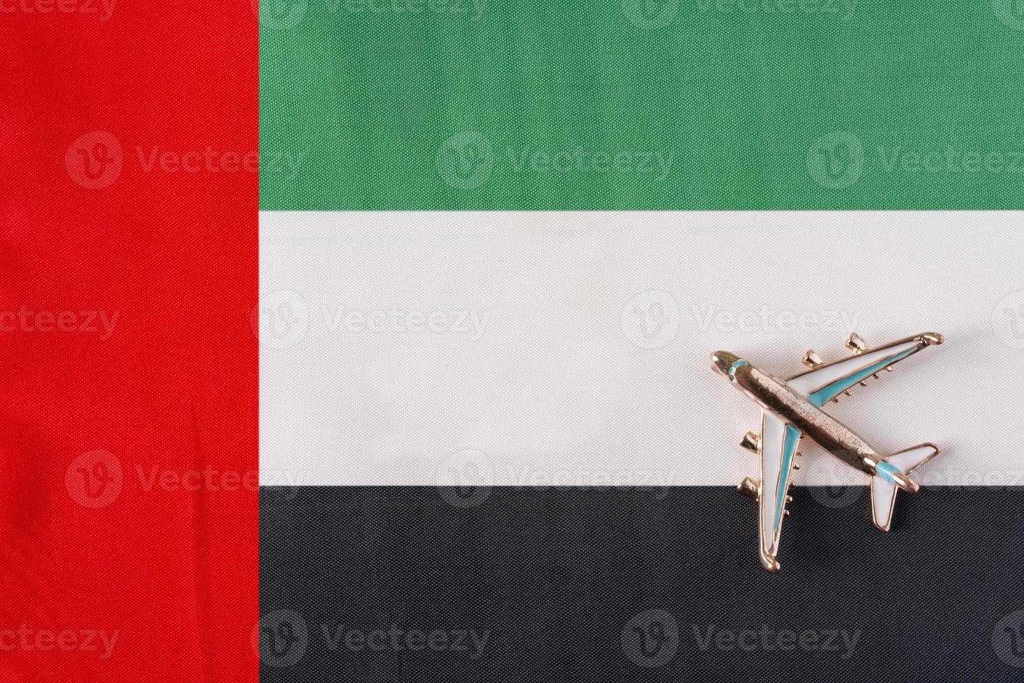 Plane over the flag of the United Arab Emirates United Arab Emirates travel concept. photo