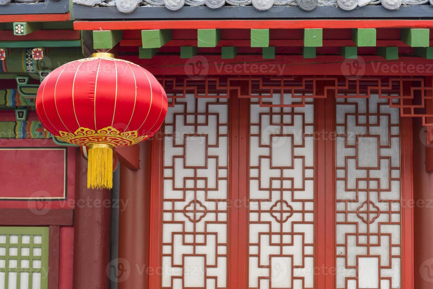 Red Chinese flashlight hanging on the house. photo