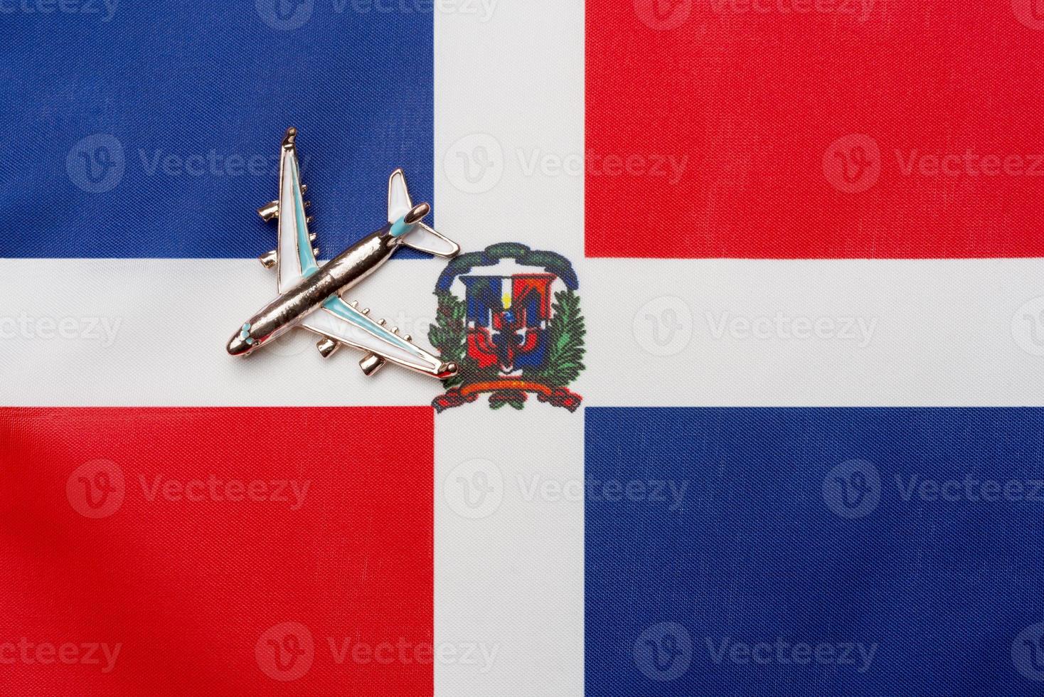 Plane over the flag of Dominican Republic travel concept. photo