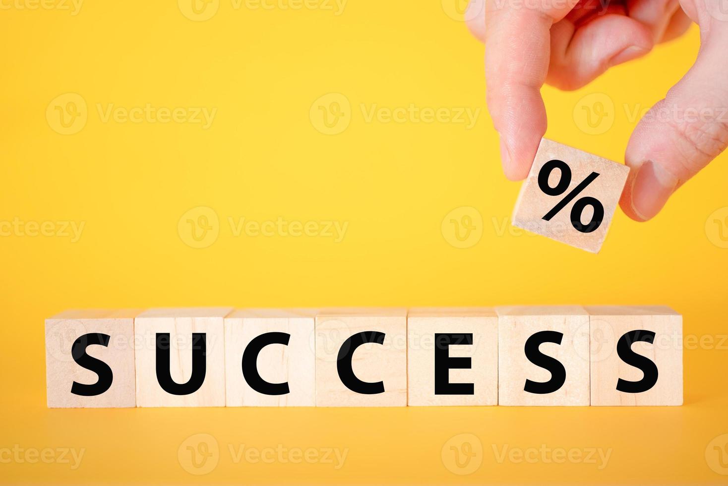 The success of the text on a yellow background of wooden cubes. photo