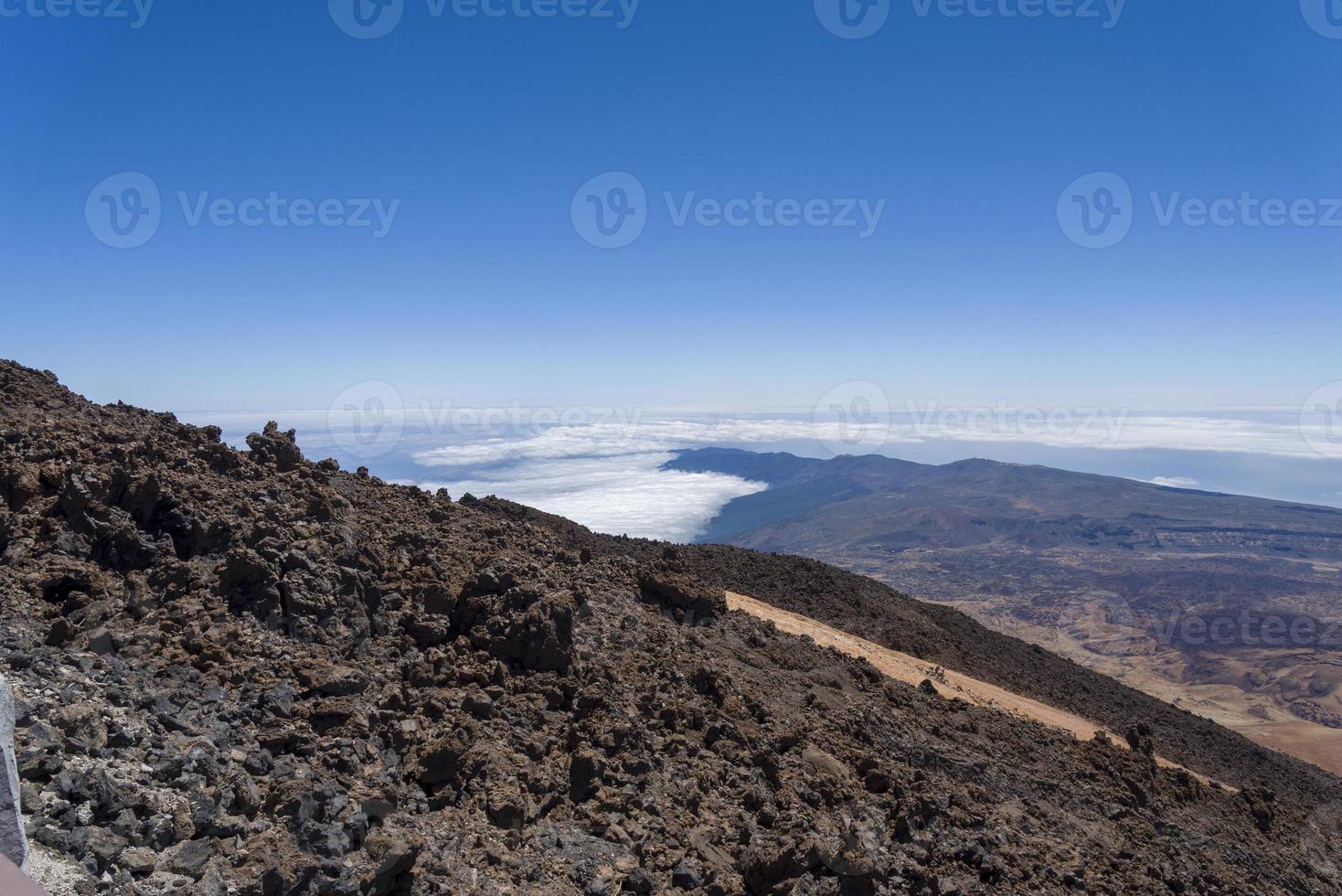 View from Teide Las Canadas Caldera volcano with solidified lava. Teide national Park mountain landscape above the clouds. Tenerife, Canary Islands, Spain. photo