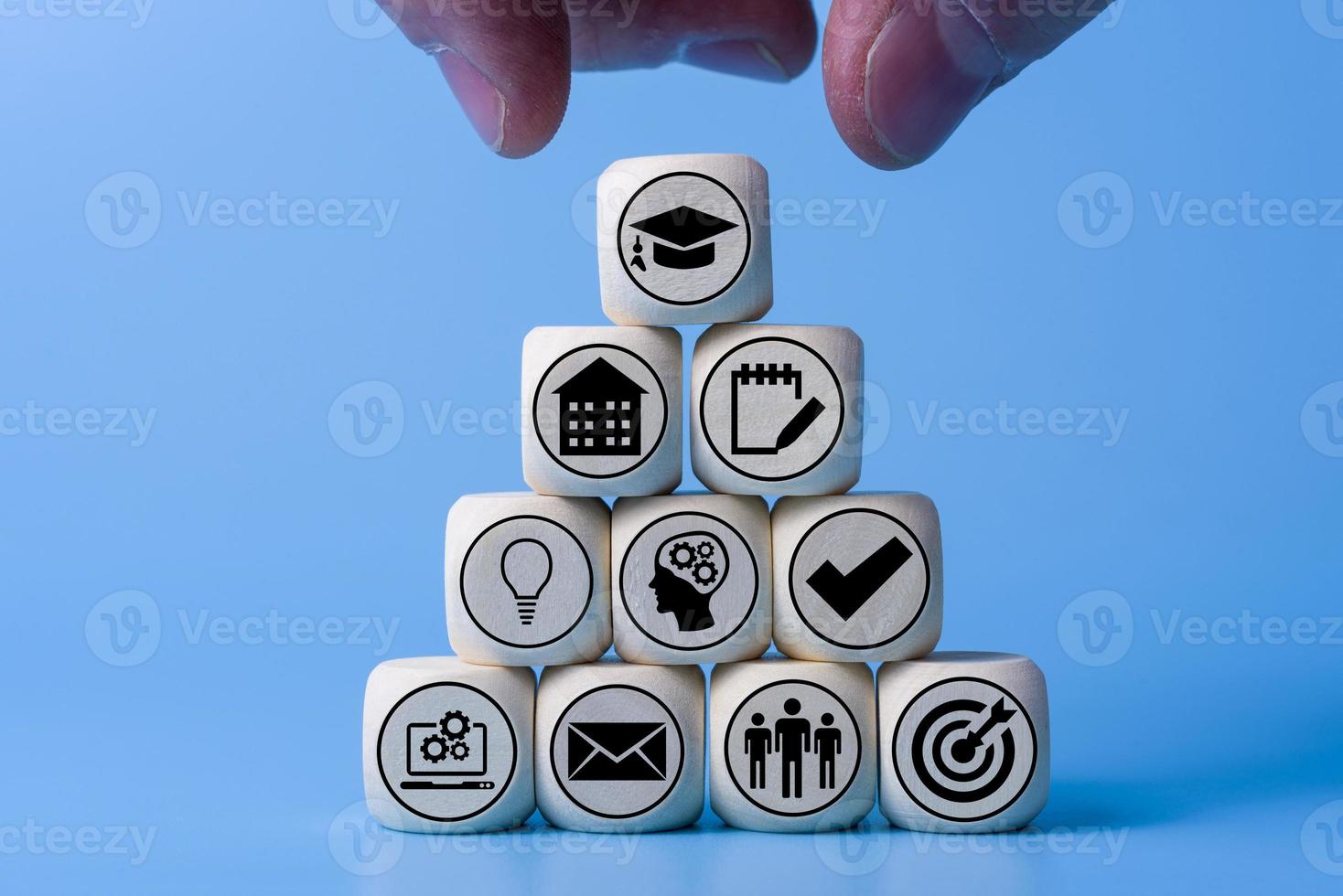 Education concept with icons on wooden cubes, blue background. photo