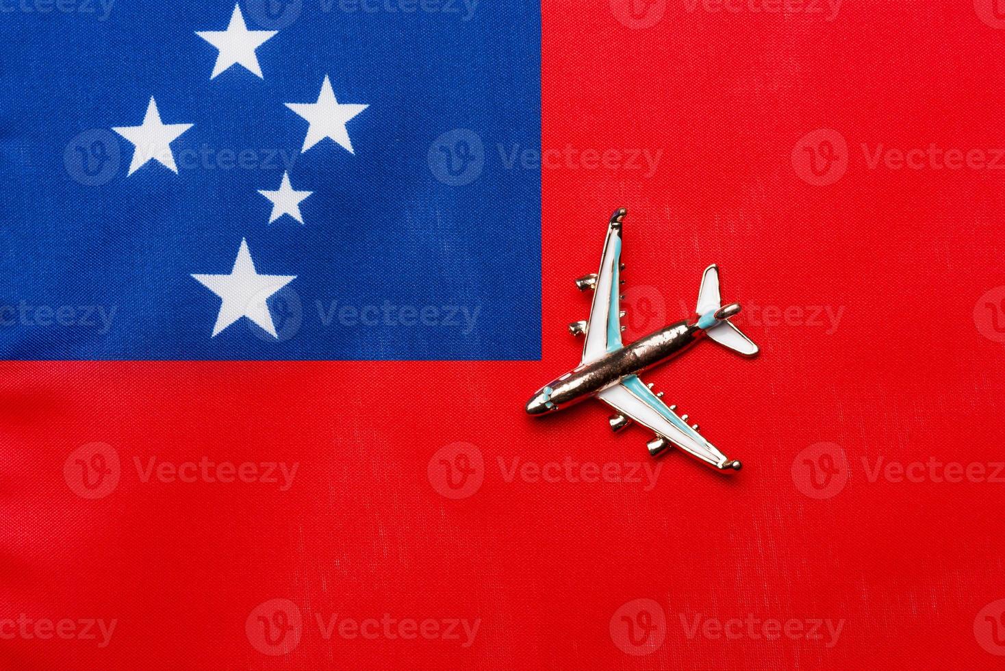 Plane over the flag of Samoa the concept of travel and tourism. photo