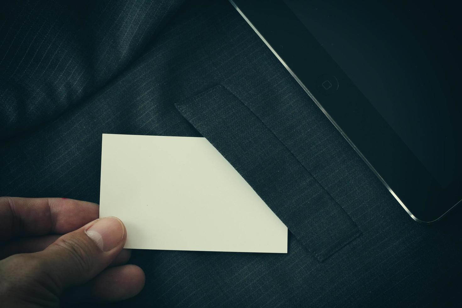 Blank corporate identity package business card with dark grey suit background. photo