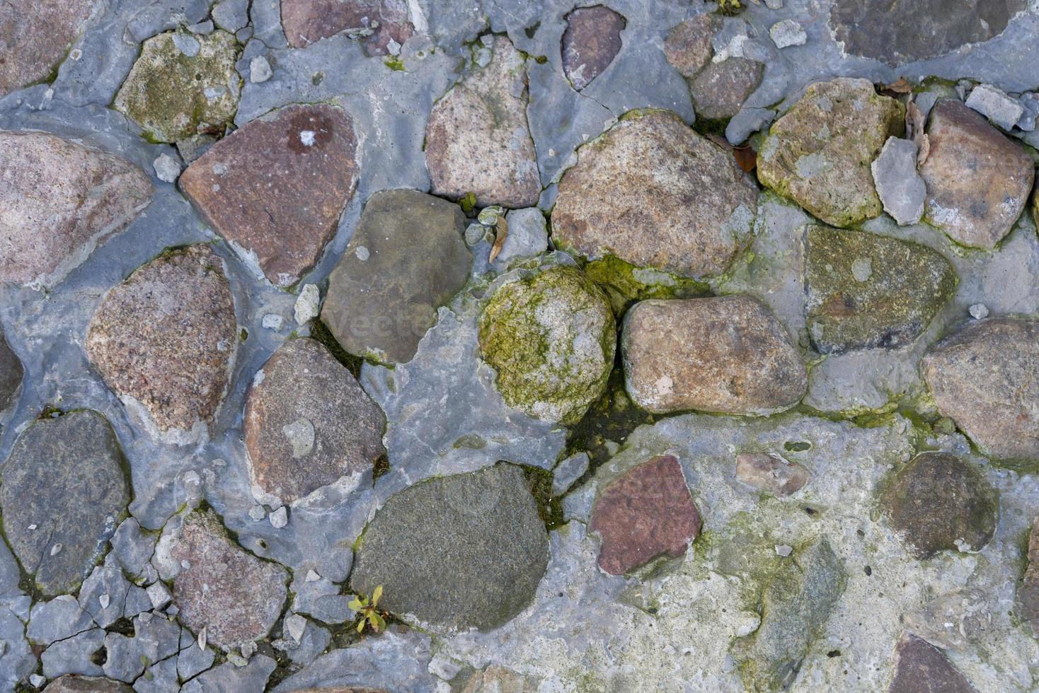 Close up of cobblestones on sidewalk, covered in ice photo