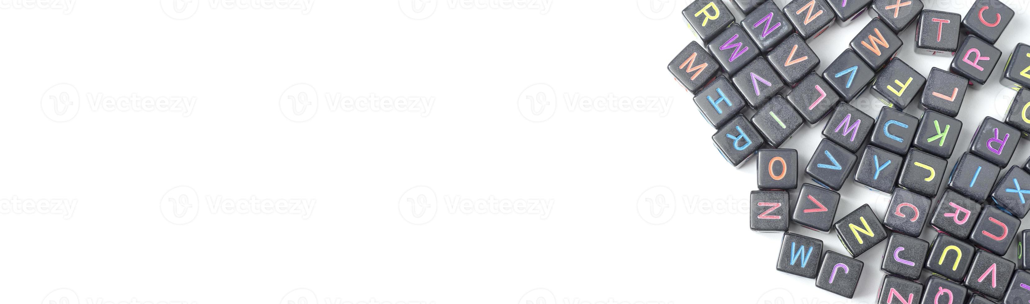 A lot of small cubes with letters on a white background. Copy Space. photo