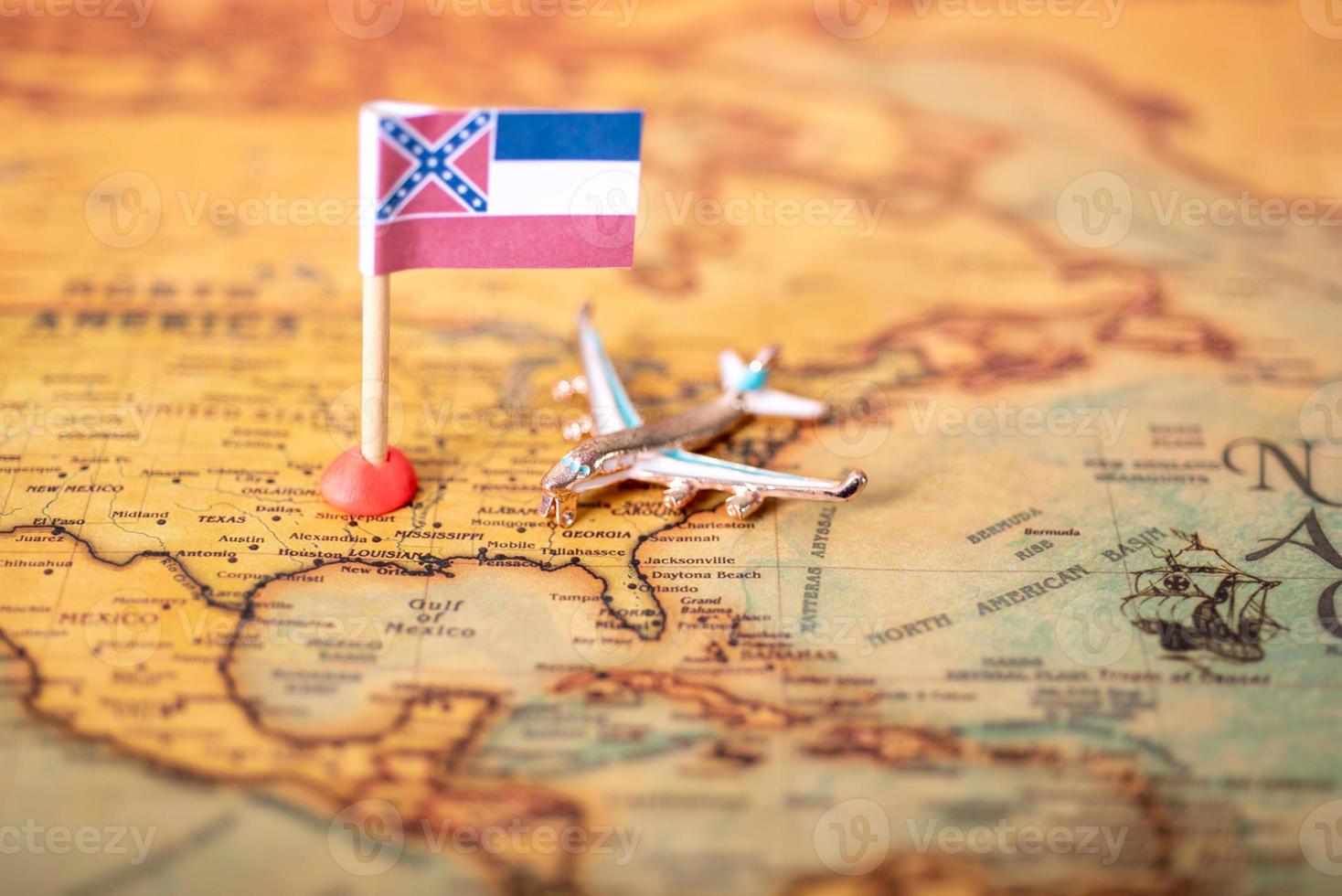 The flag of Mississippi and the plane on the map of the old world. photo