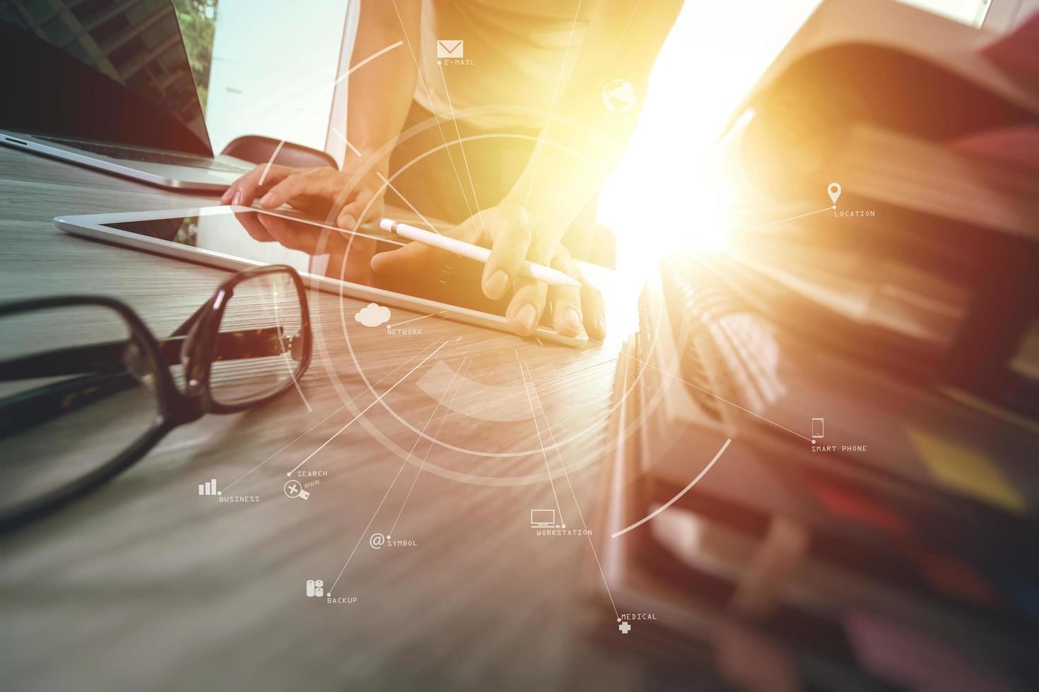 businessman working with mobile phone and digital tablet and laptop computer on wooden desk in modern office with virtual icon diagram photo