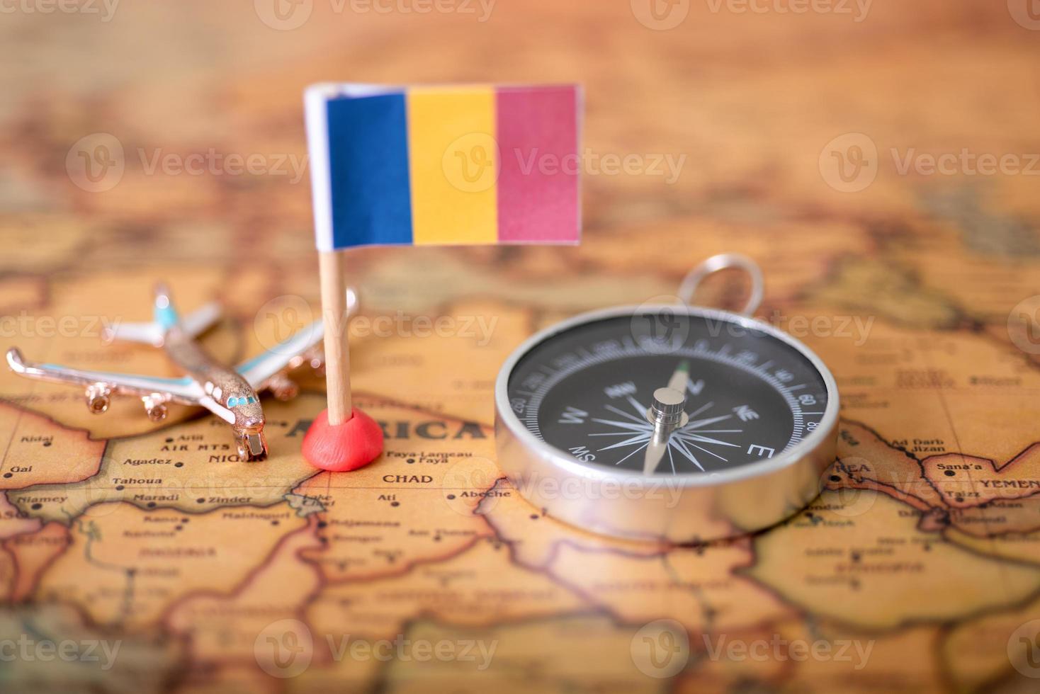 Flag of Romania, compass and airplane on the world map. photo