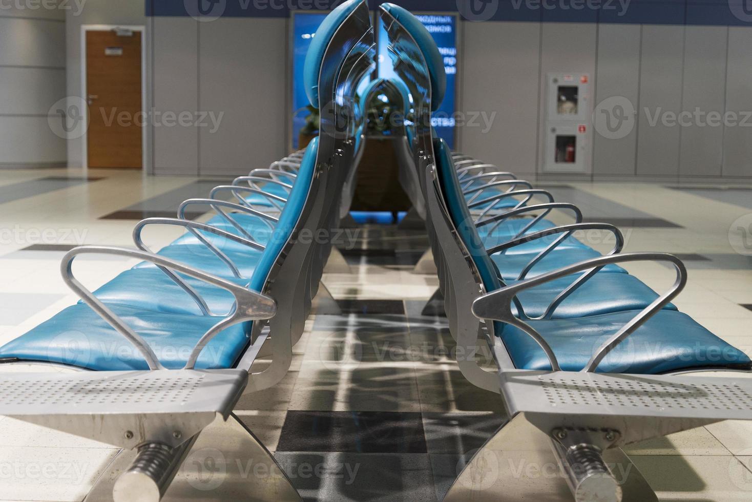 Seats without people in airport waiting building. photo