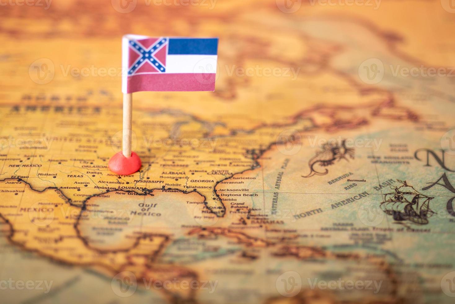 The flag of Mississippi on the old world map. photo